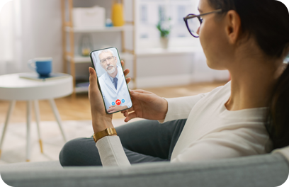 Young Girl Sick at Home Using Smartphone to Talk to Her Doctor via Video Conference Medical App. Woman Checks Possible Symptoms with Professional Physician, Using Online Video Chat Application