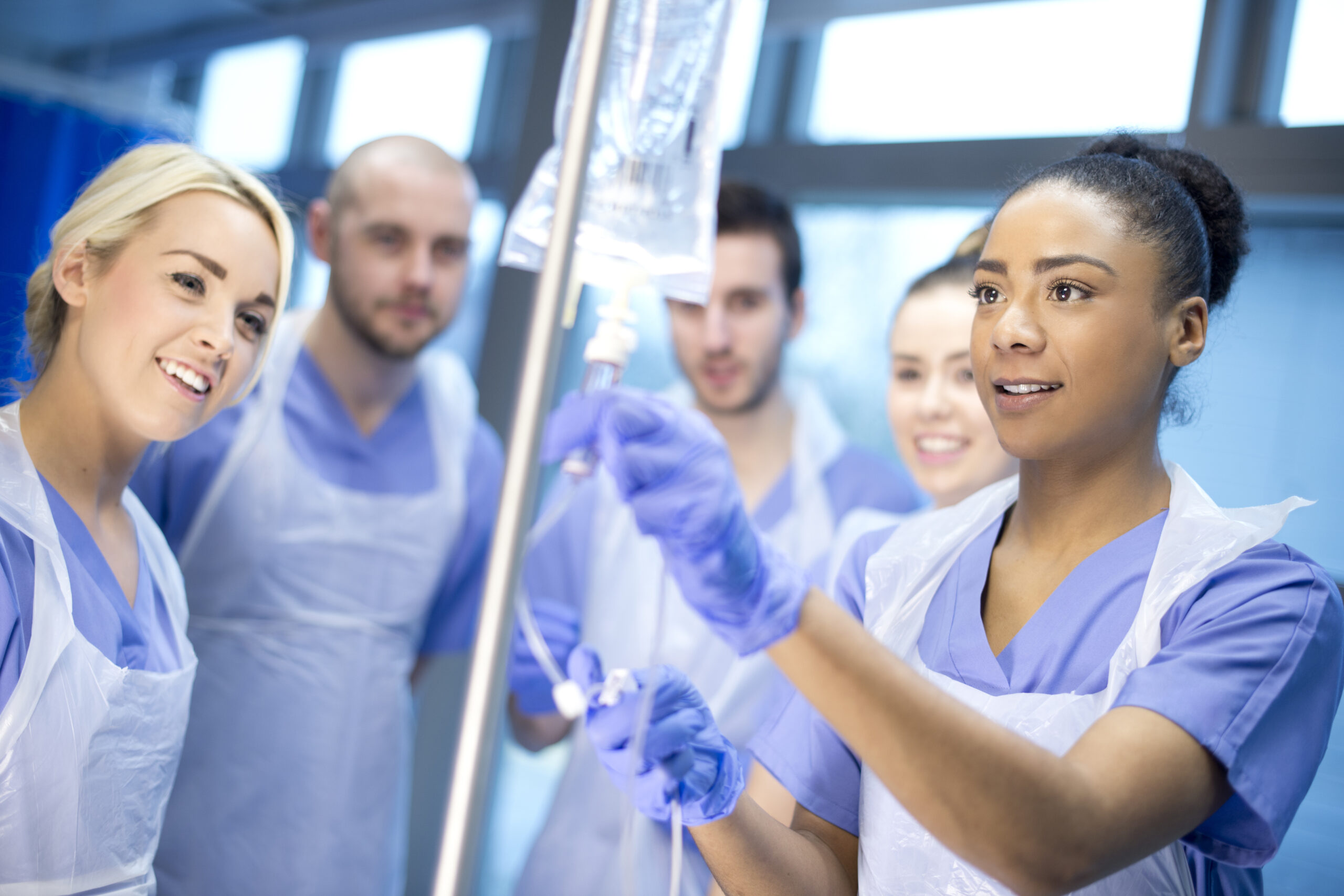 Teamwork, healthcare and medicine with a doctor, nurse and team working together on a glass board in the hospital. Planning, strategy and research in the development and innovation of medical care