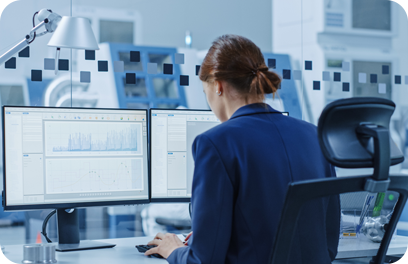 Portrait of Young and Confident Industrial Engineer Working on Computer, on Screen CAD Software Showing New Generation Electric Engine. Industrial Factory with High-Tech CNC Machinery.