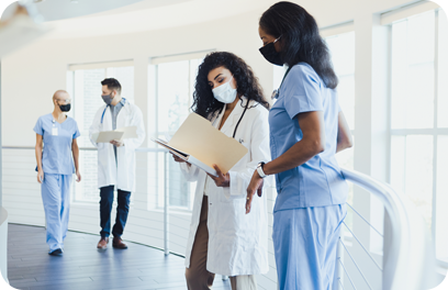 Diverse doctors and nurses confer about patient records.