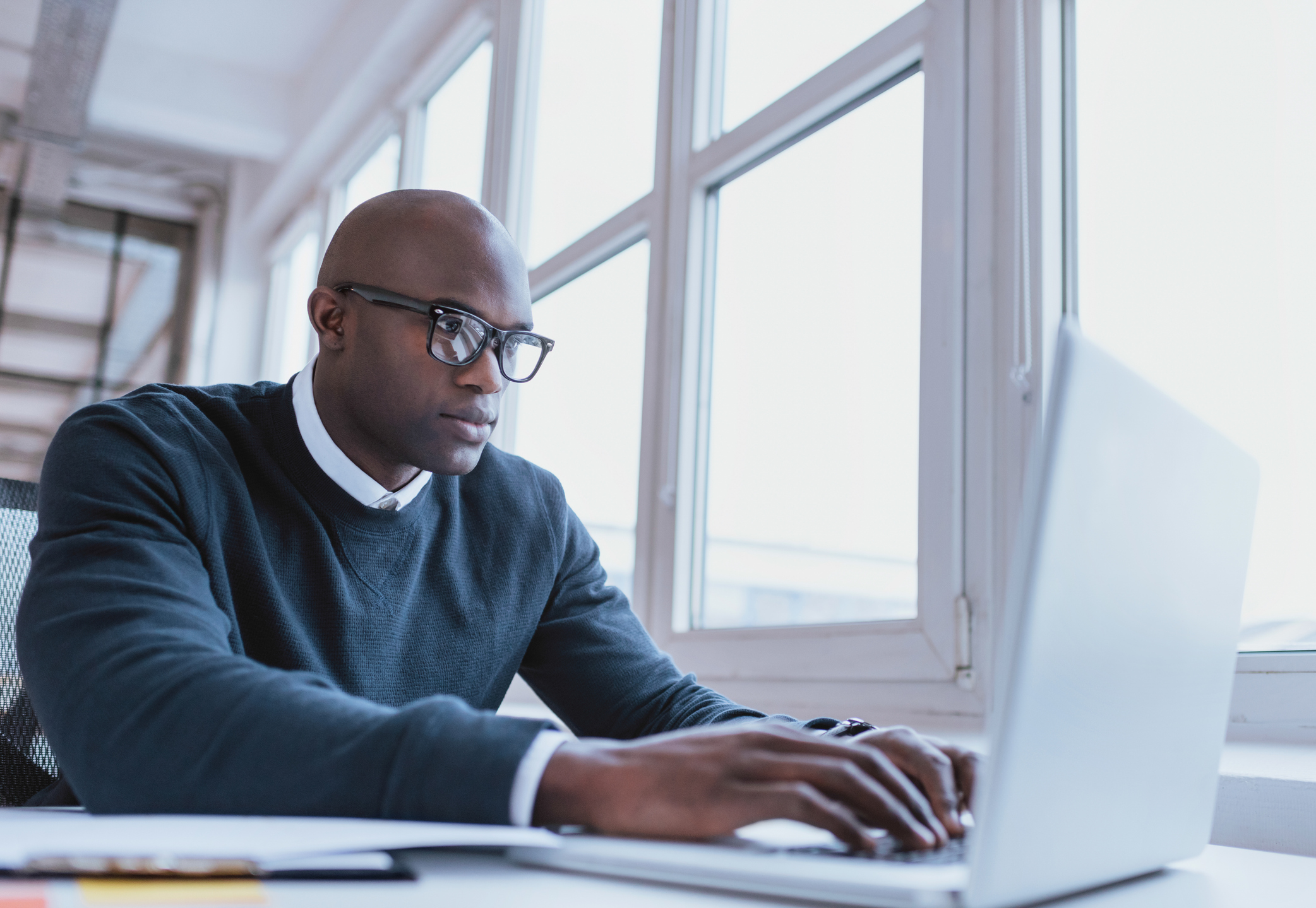 Image of african american privacy officer working on his laptop.