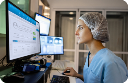 Radiologist in the control room performing a medical scan and looking at the computer monitor -healthcare and medicine concepts