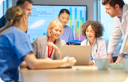 a mixed group of healthcare professional and business people meet around a conference table .