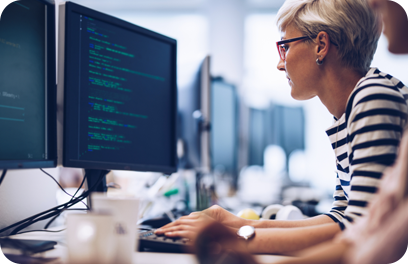 Short haired computer programmer working on a new software in the office.