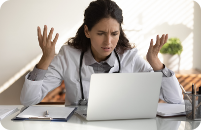 Angry female nurse work on laptop in clinic frustrated by slow internet connection on gadget. Unhappy mad woman doctor use computer in hospital confused with operational problem or spam on device.